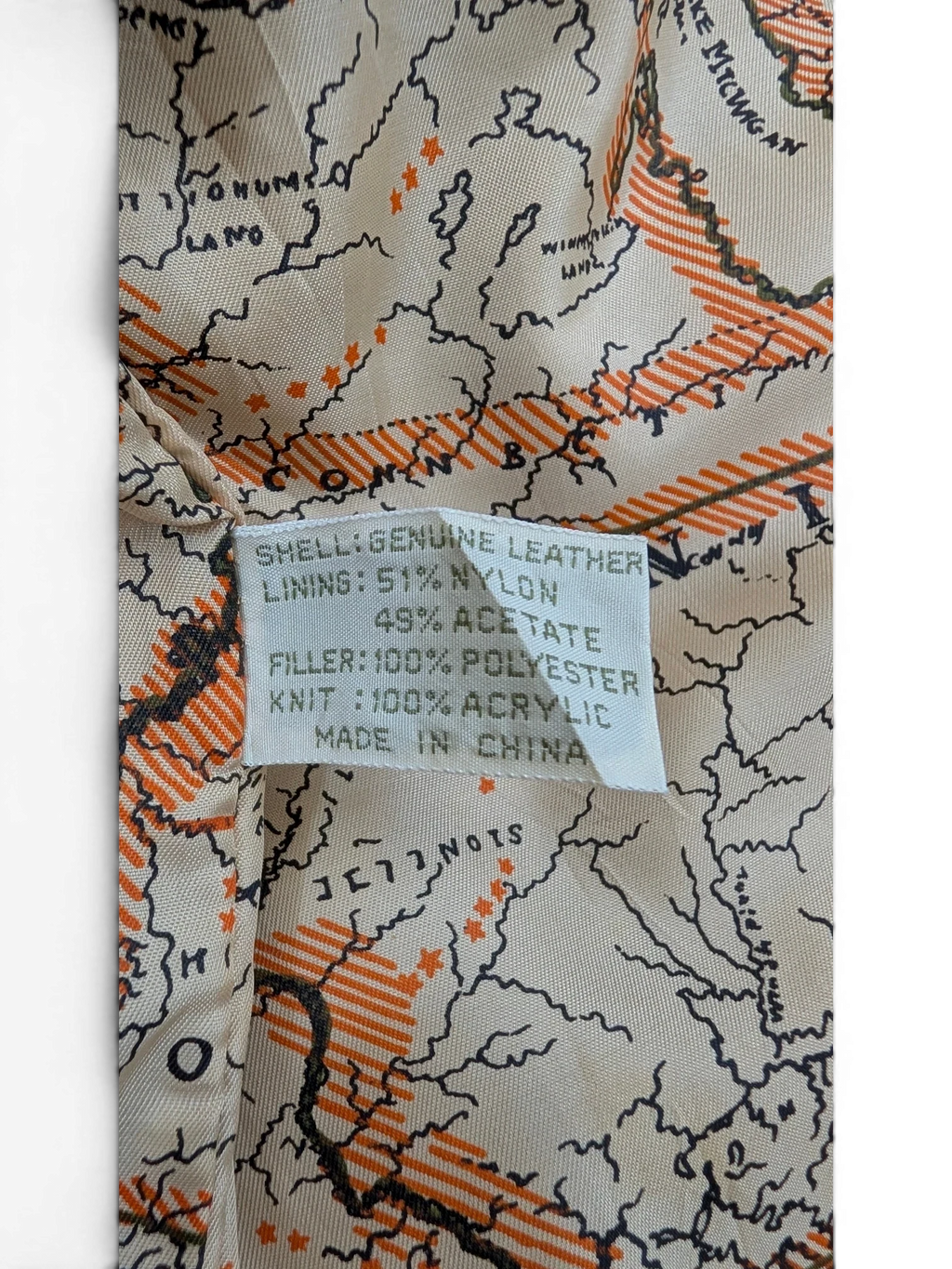 JAKE & IPI American Weekend leather jacket lining with a map print of the Great Lakes region and material composition label.