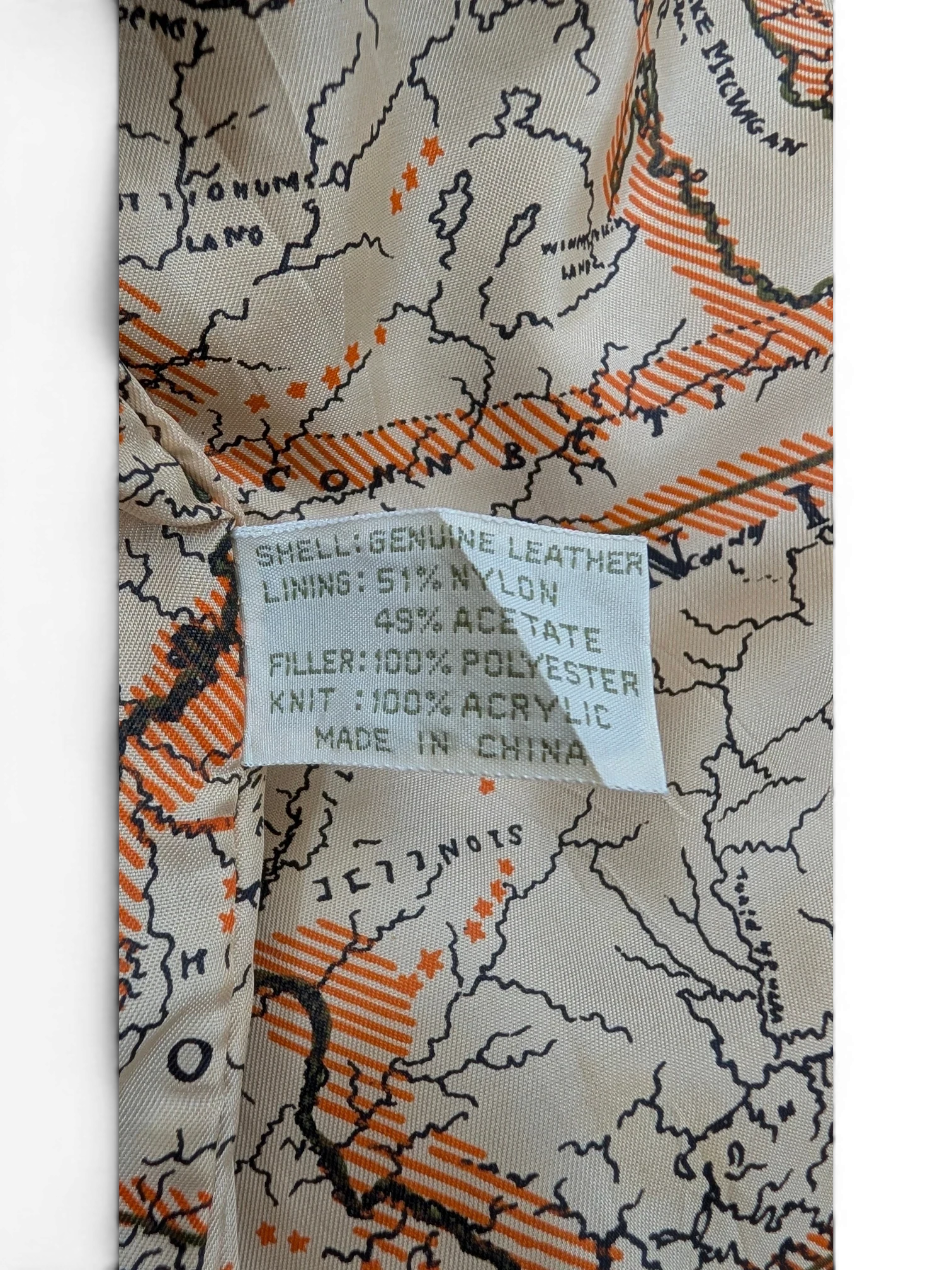 JAKE & IPI American Weekend leather jacket lining with a map print of the Great Lakes region and material composition label.