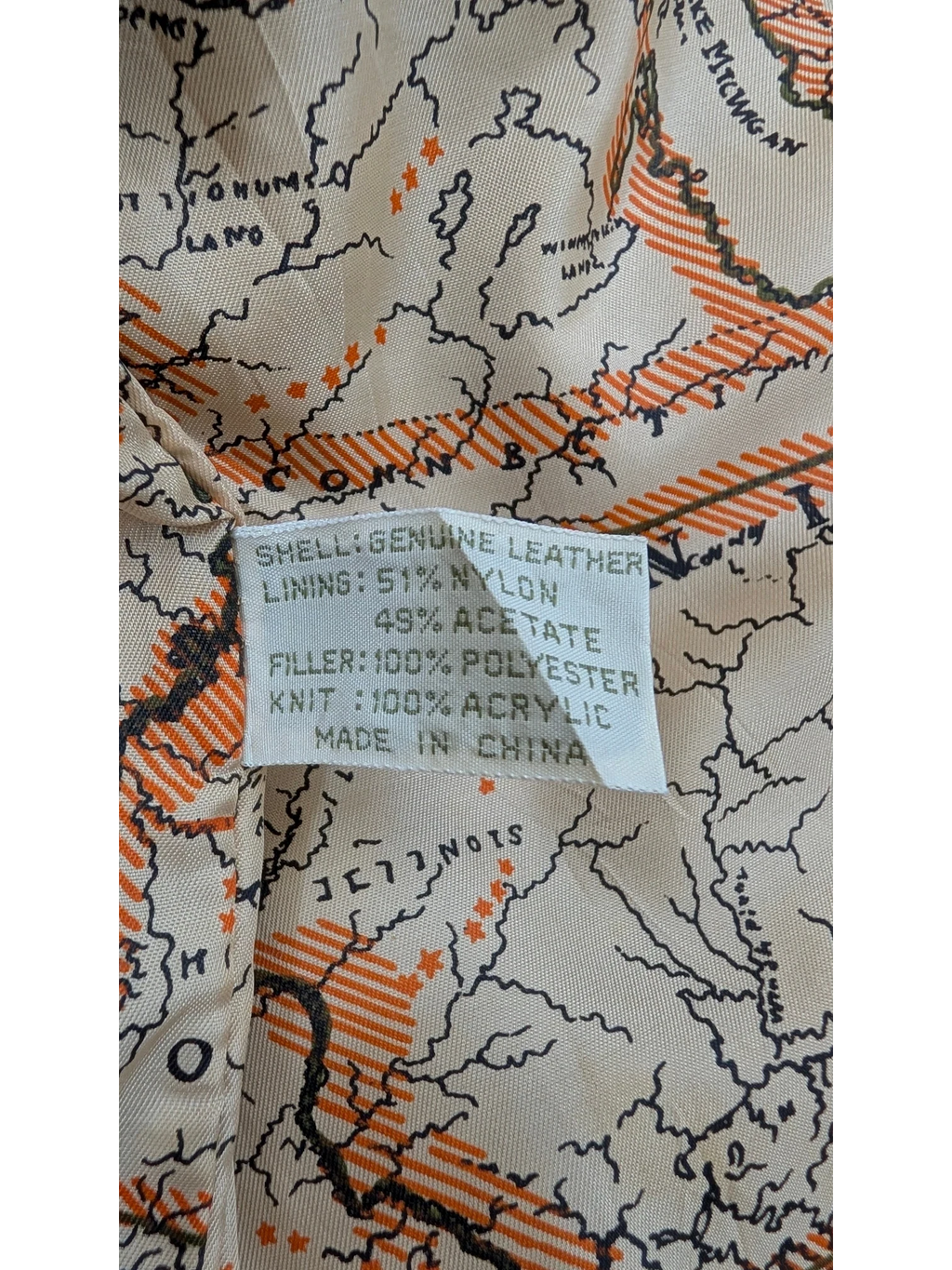 JAKE & IPI American Weekend leather jacket lining with a map print of the Great Lakes region and material composition label.