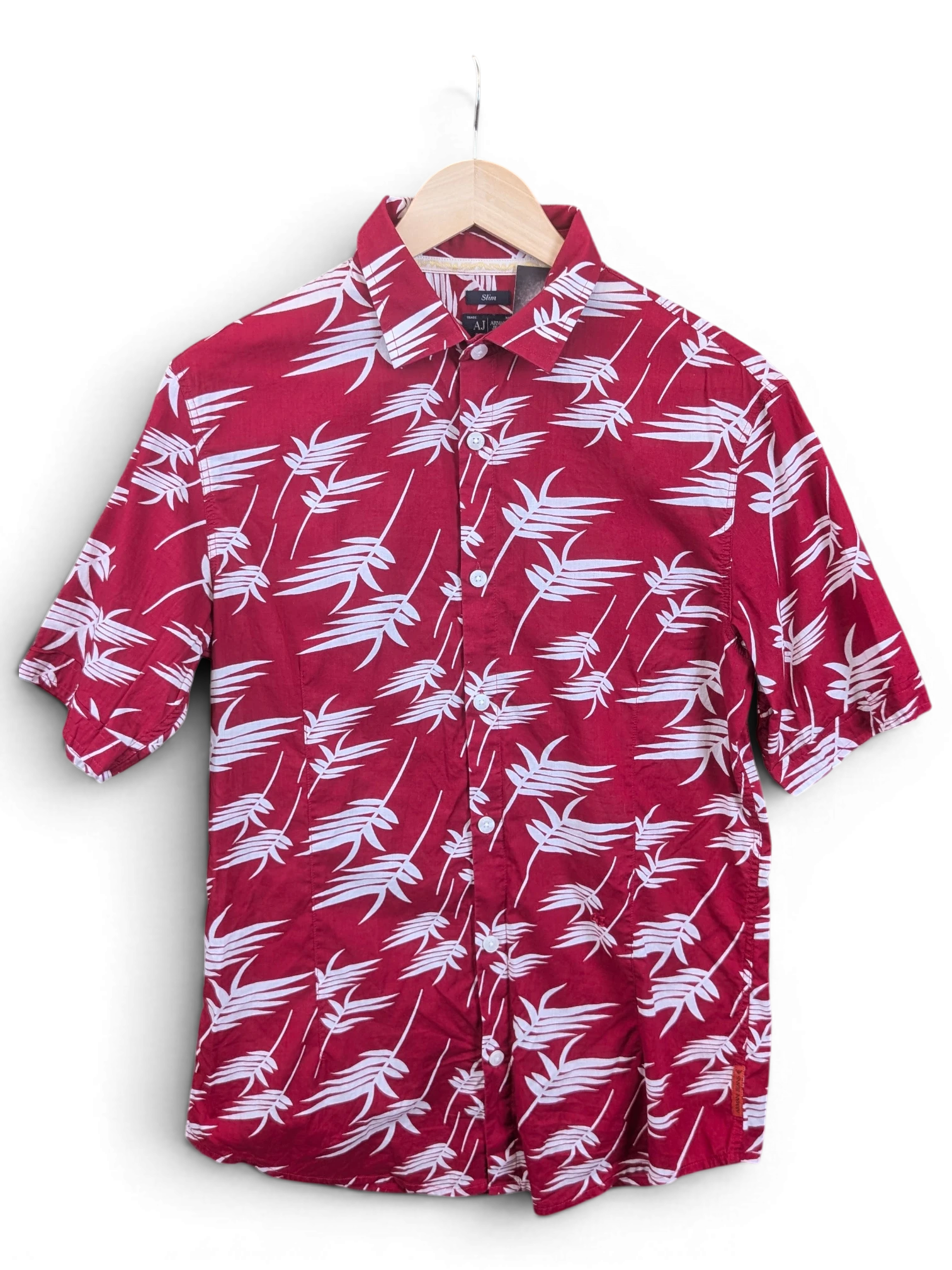 JAKE & IPI Armani Jeans red short-sleeve button-down shirt featuring a white tropical leaf print on a hanger.