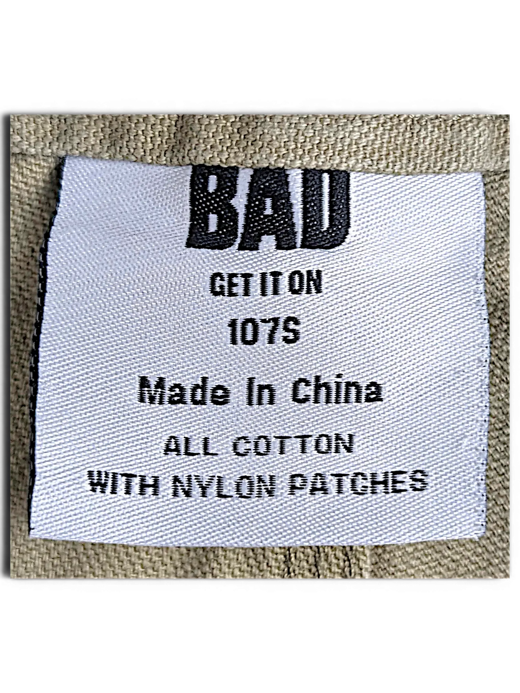JAKE & IPI Bad Get It On workwear pants label showing olive green cotton fabric and nylon patch details