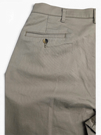 JAKE & IPI vintage beige cotton-blend pleated trousers featuring a single buttoned back pocket detail.