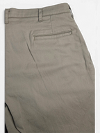 JAKE & IPI beige stretch-cotton pleated trousers featuring a rear welt pocket detail.