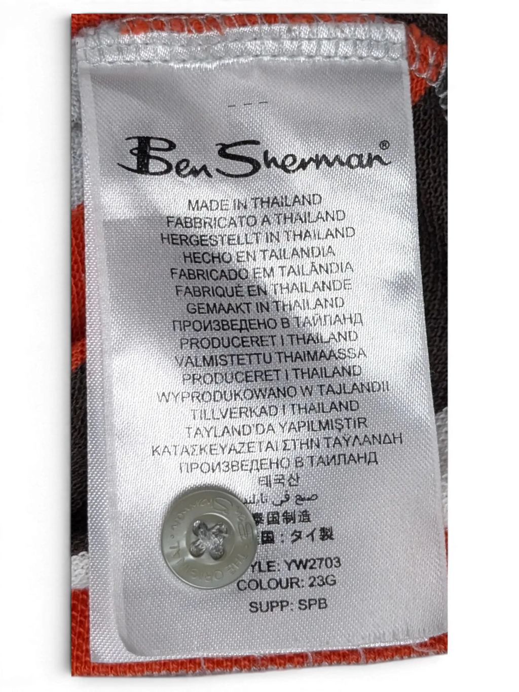 JAKE & IPI Ben Sherman striped polo shirt care label with spare button and fabric detail in grey, red, and white.