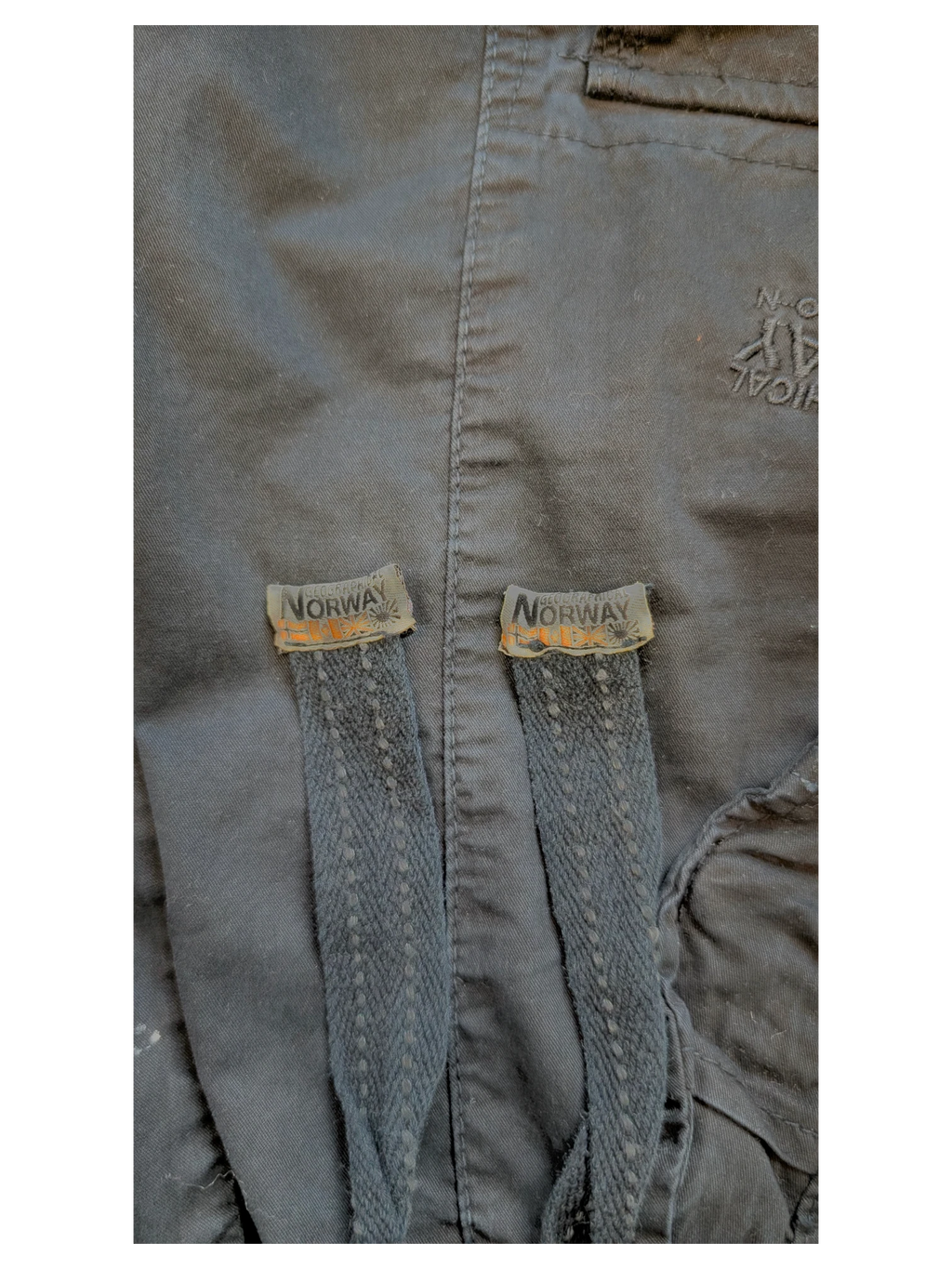 JAKE & IPI black cotton cargo pants with drawstring details and Geographical Norway tags.