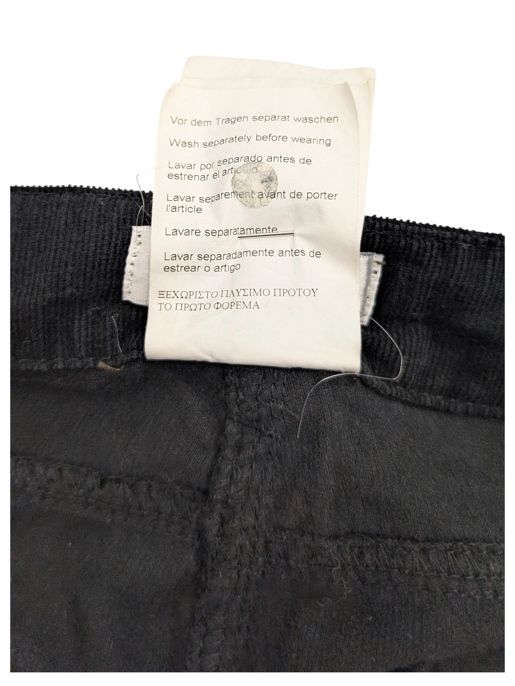 JAKE & IPI black corduroy cargo pants with care instructions label.