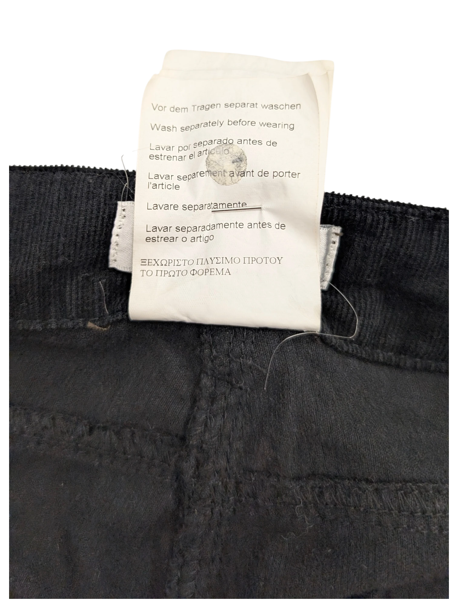 JAKE & IPI black corduroy cargo pants with care instructions label.