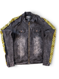 JAKE & IPI Rage of a Rebellion black denim jacket with distressed details and yellow checkered racing stripes on sleeves.