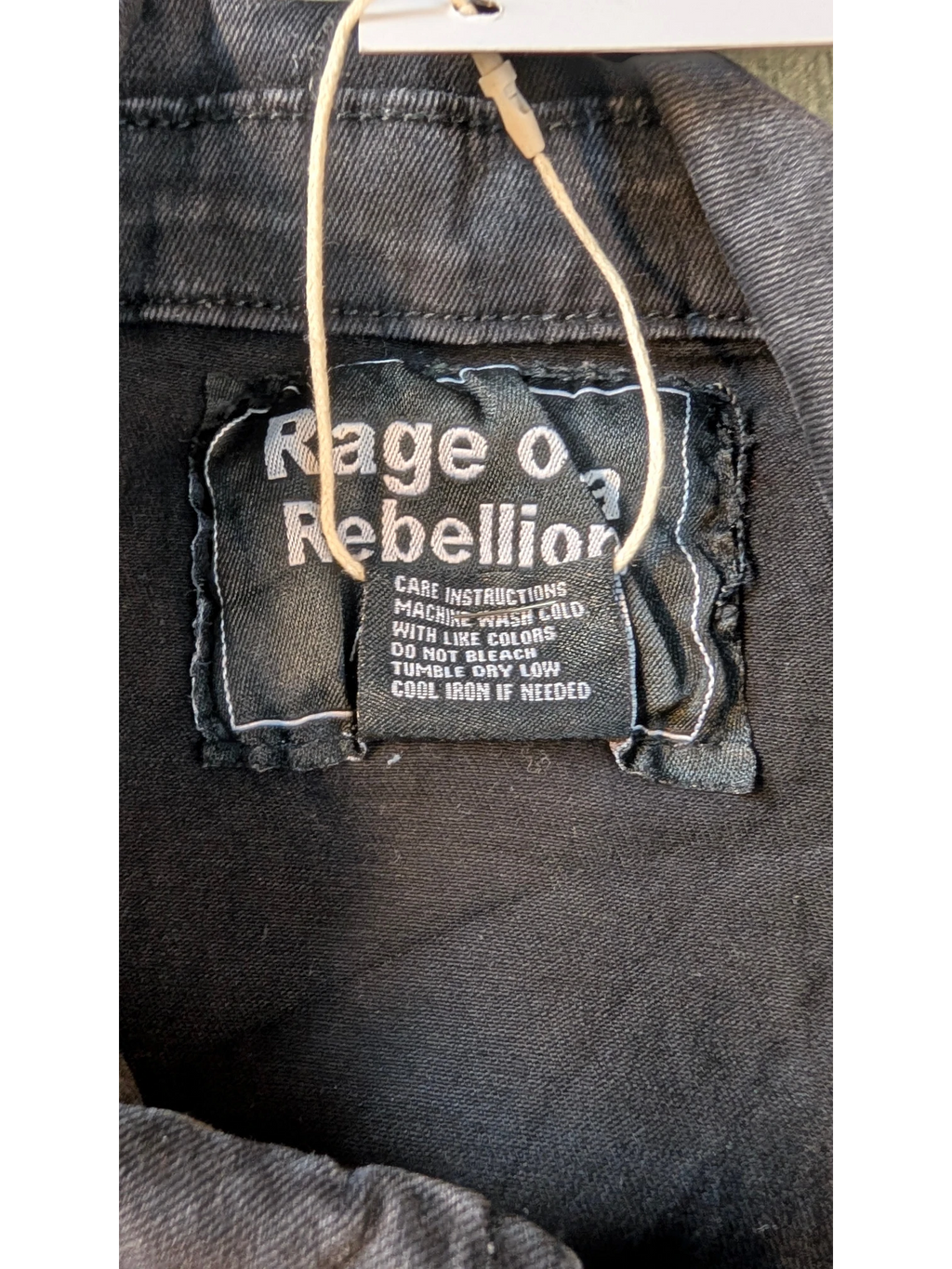 JAKE & IPI black distressed denim jacket with "Rage of a Rebellion" graphic on the back label.