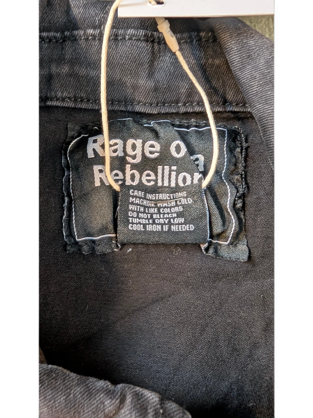 JAKE & IPI black distressed denim jacket with "Rage of a Rebellion" graphic on the back label.