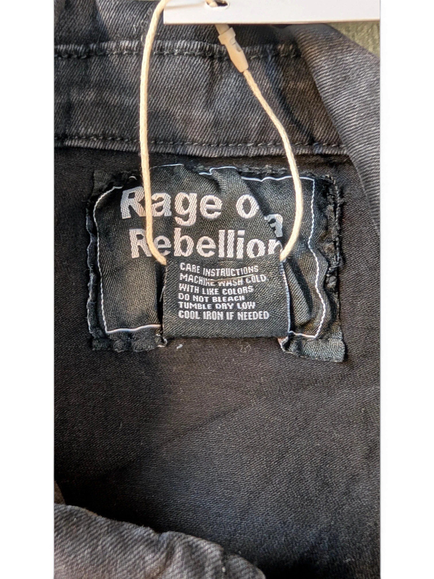 JAKE & IPI black distressed denim jacket with "Rage of a Rebellion" graphic on the back label.