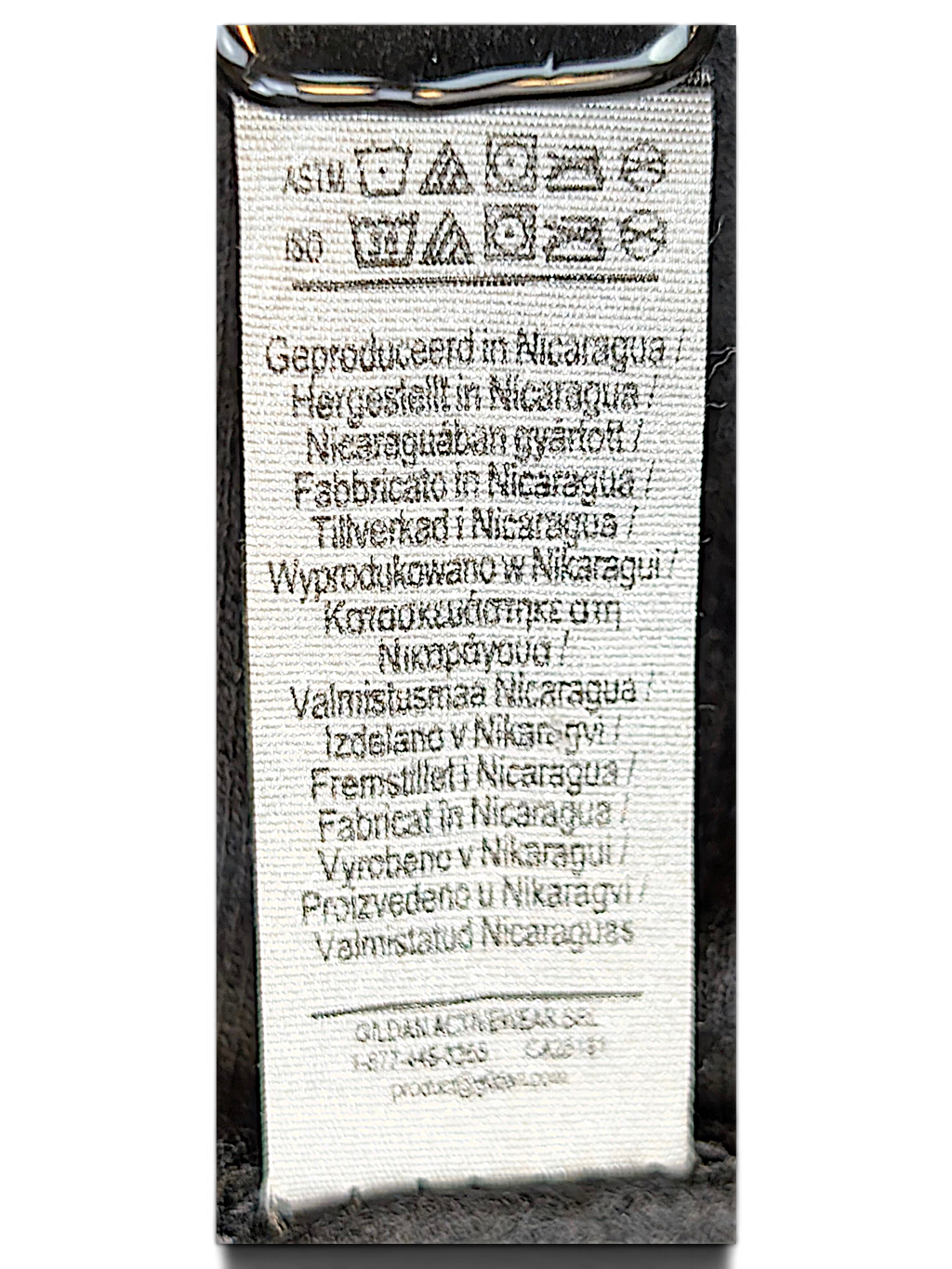 JAKE & IPI black hoodie care label showing manufacturing details and washing instructions in multiple languages