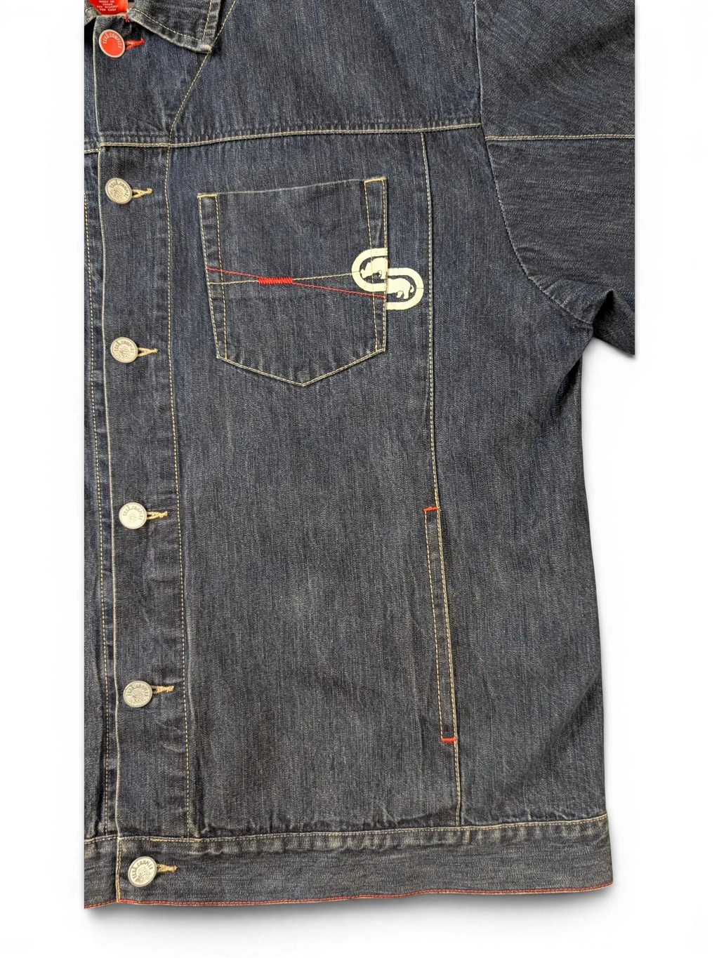 JAKE & IPI blue denim jacket with red stitching detail and embroidered logo on chest pocket.