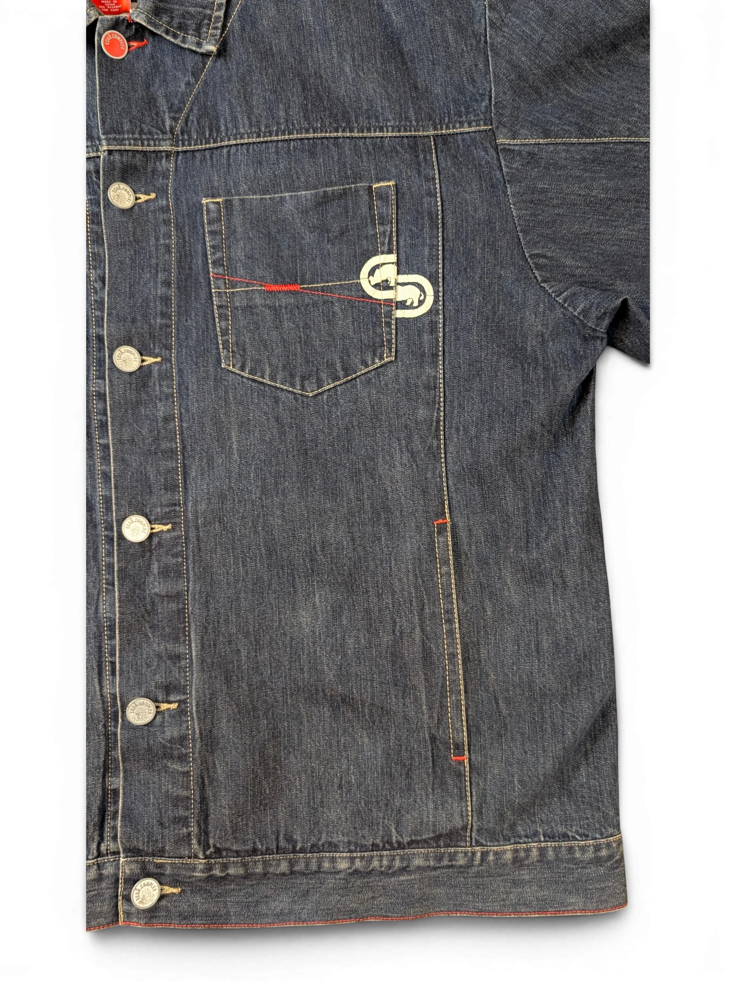 JAKE & IPI blue denim jacket with red stitching detail and embroidered logo on chest pocket.