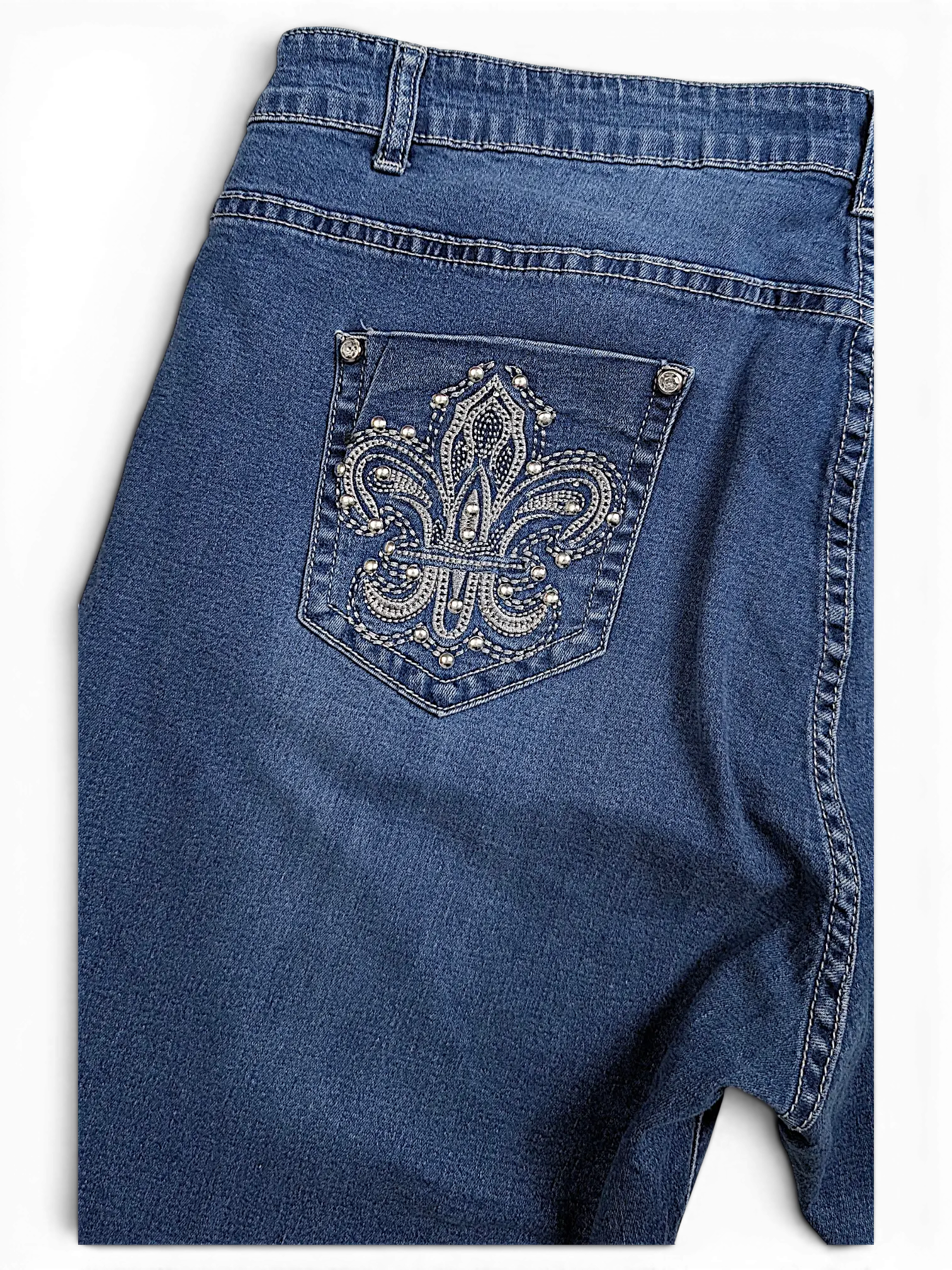 JAKE & IPI blue denim jeans featuring a back pocket with a decorative silver rhinestone fleur-de-lis emblem.