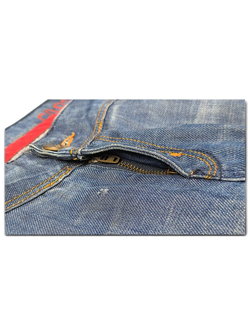 JAKE & IPI blue denim jeans featuring a metal zipper fly with orange contrast stitching and red interior trim