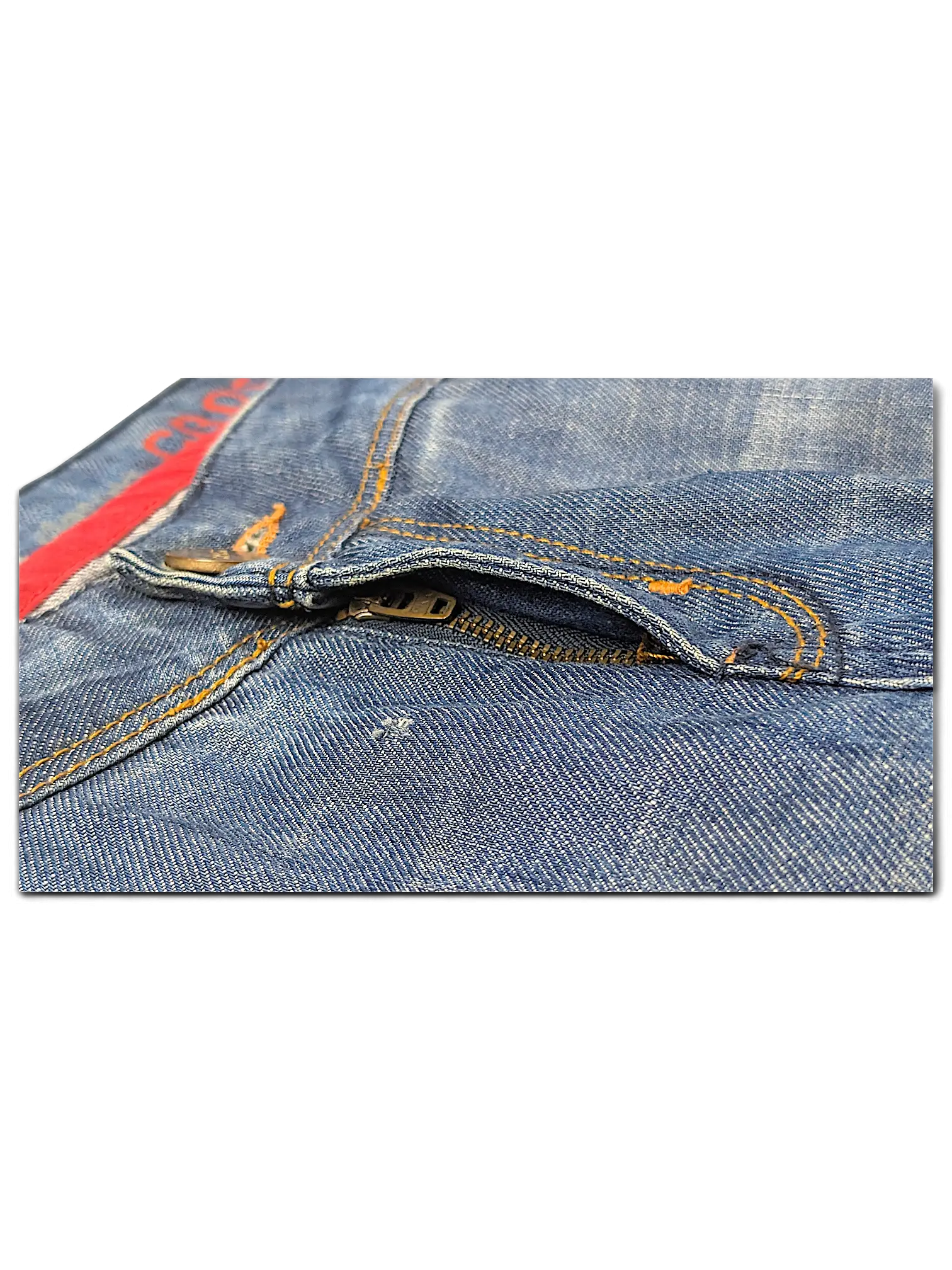 JAKE & IPI blue denim jeans featuring a metal zipper fly with orange contrast stitching and red interior trim