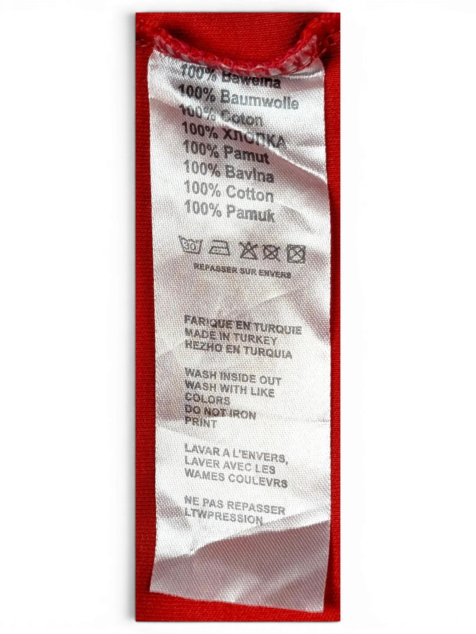 JAKE & IPI BOSS Green polo shirt interior fabric care label showing 100 percent cotton composition and care symbols