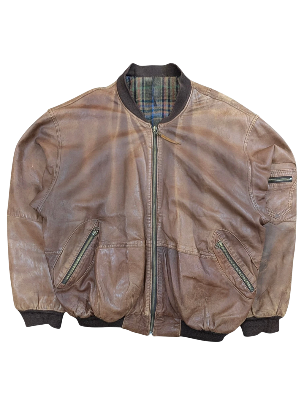 JAKE & IPI brown distressed leather bomber jacket with plaid lining and zippered pockets.