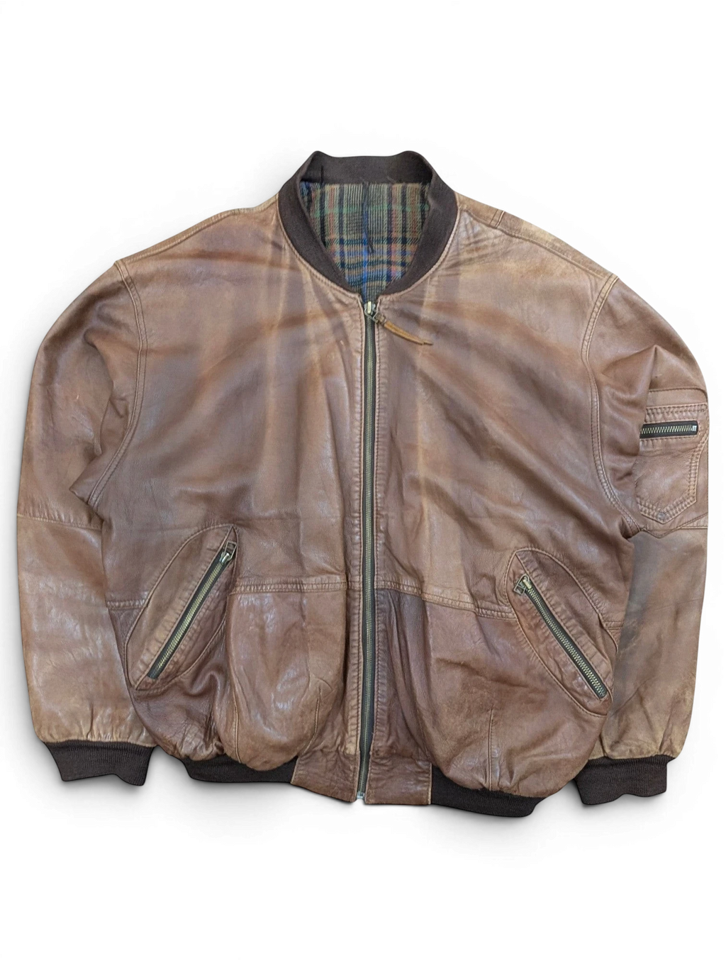 JAKE & IPI brown distressed leather bomber jacket with plaid lining and zippered pockets.