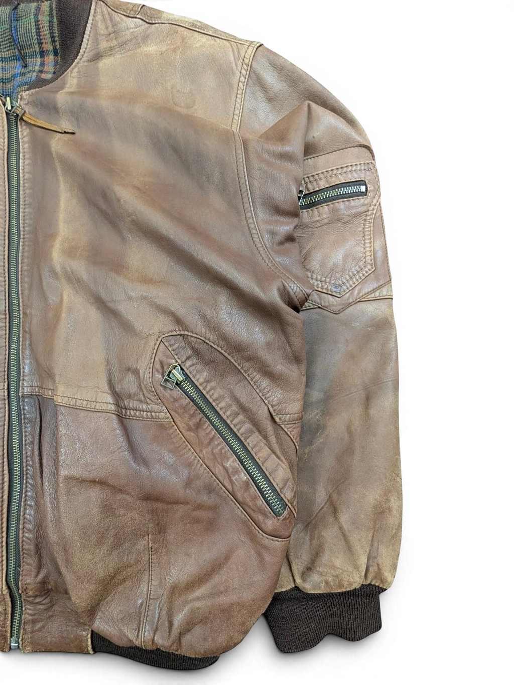 JAKE & IPI brown distressed leather bomber jacket with plaid lining and zippered pockets.