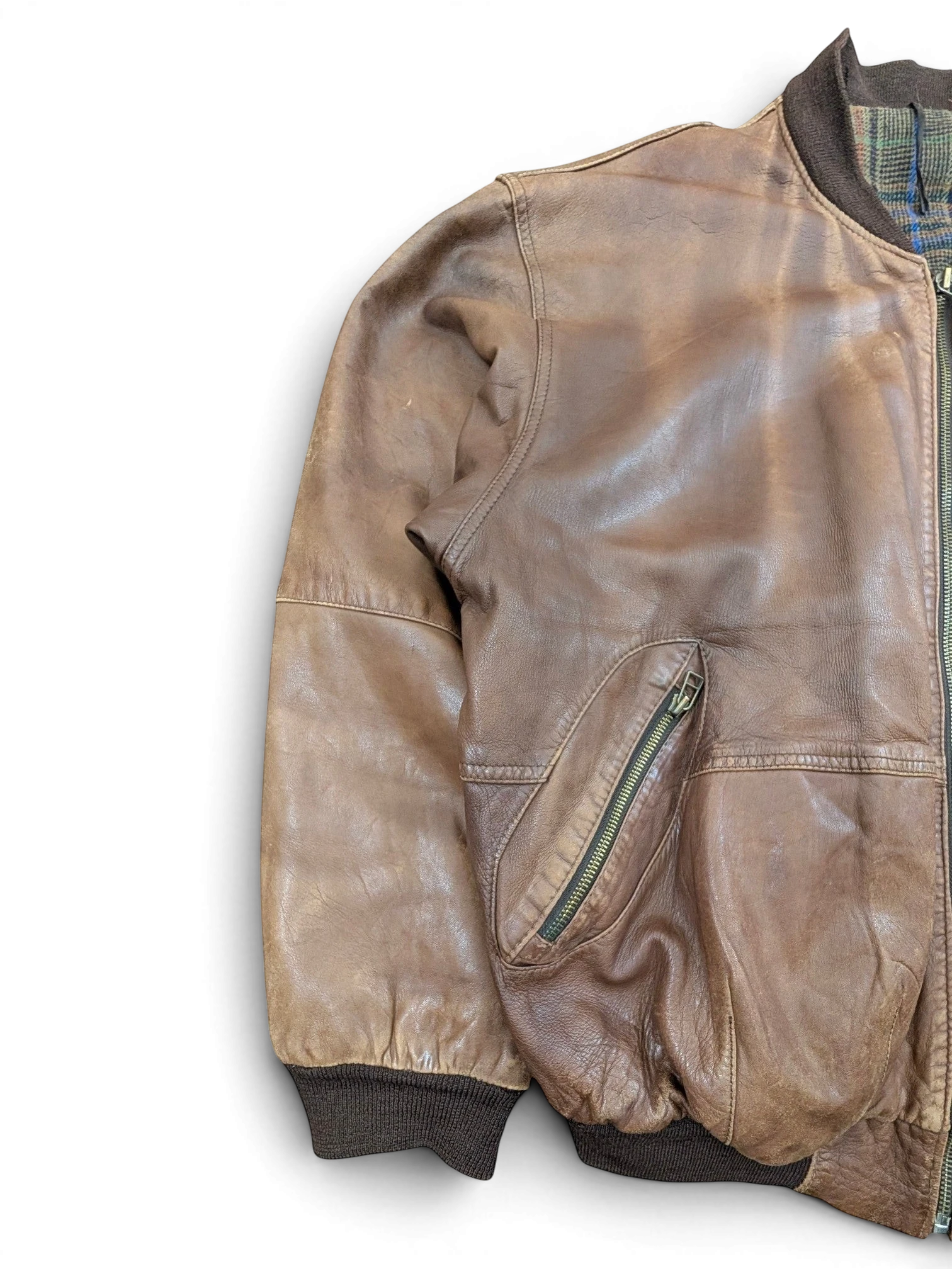 JAKE & IPI brown distressed leather bomber jacket with zippered pocket and plaid lining.