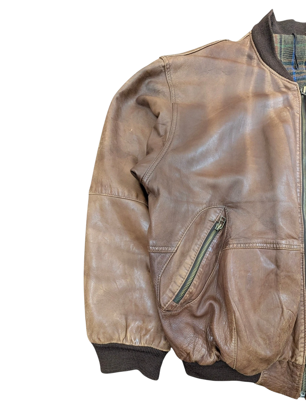 JAKE & IPI brown distressed leather bomber jacket with zippered pocket and plaid lining.
