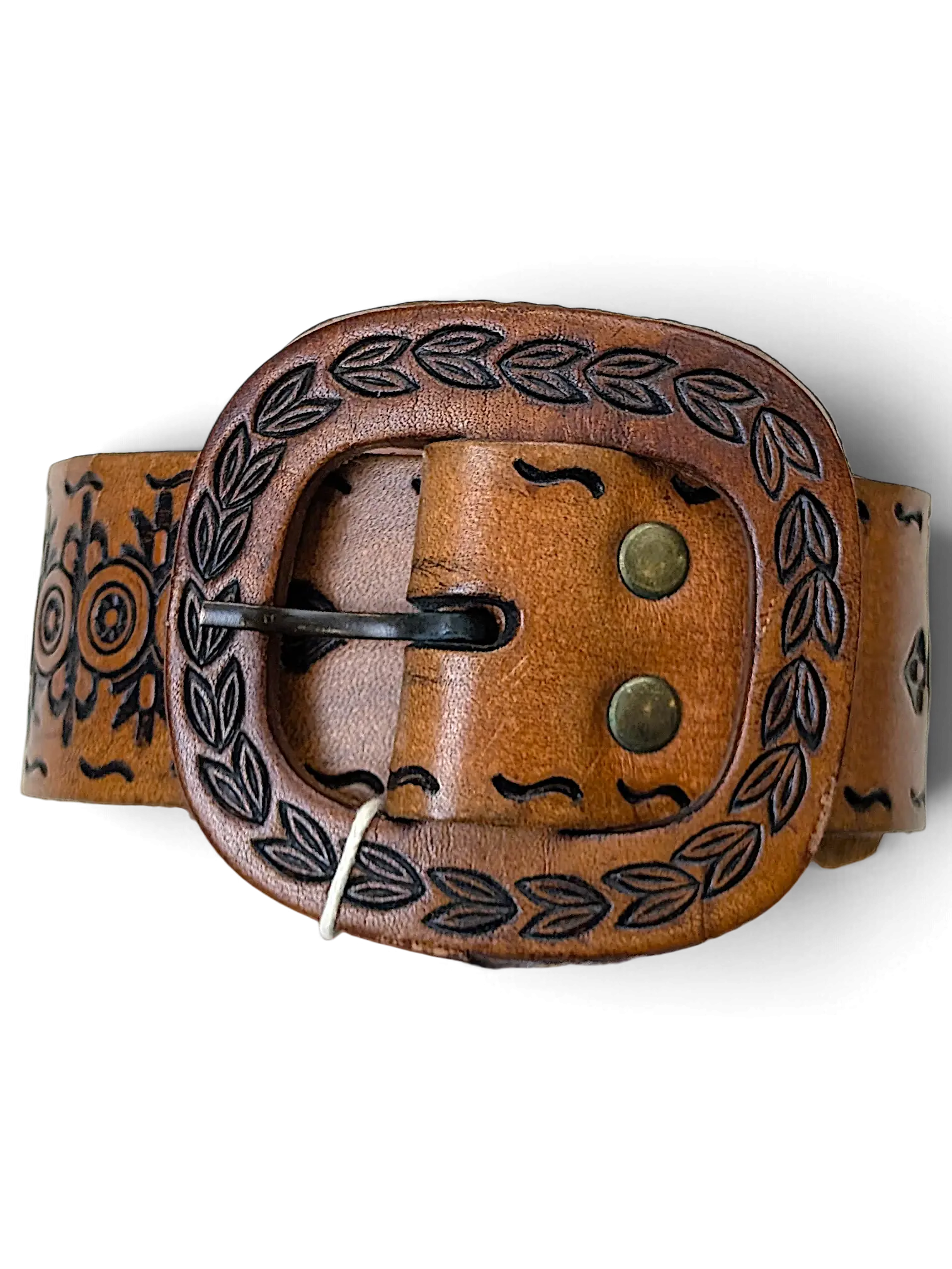 JAKE & IPI brown leather belt featuring an ornate embossed buckle with leaf patterns and intricate side detailing.
