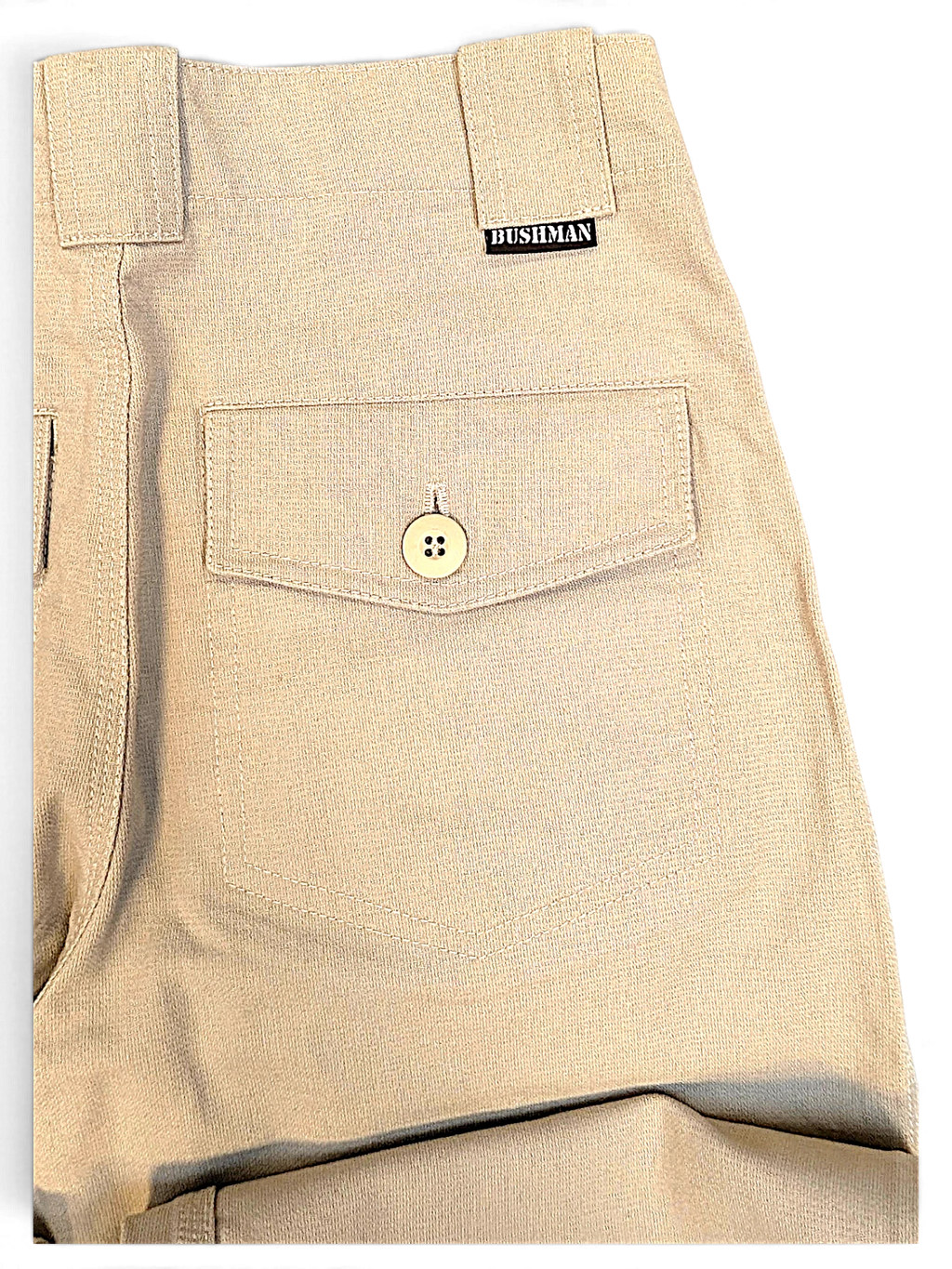Close-up of JAKE & IPI Bushman beige utility trousers featuring a buttoned flap pocket and branded woven label.