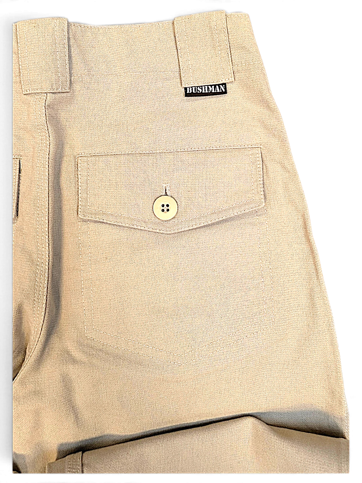 Close-up of JAKE & IPI Bushman beige utility trousers featuring a buttoned flap pocket and branded woven label.