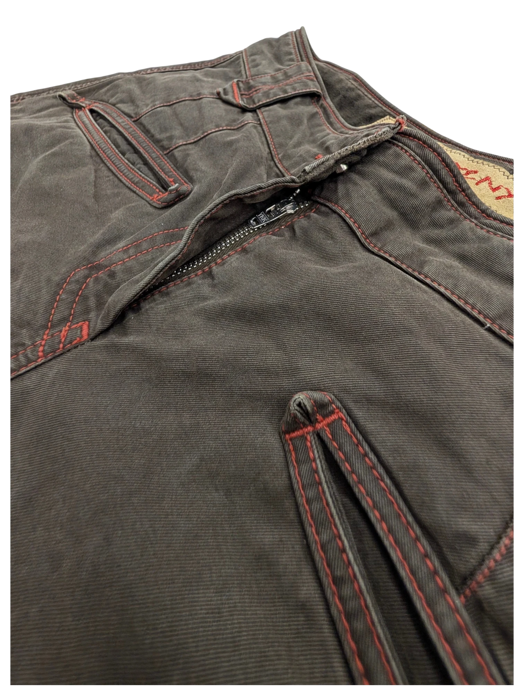JAKE & IPI dark brown cotton cargo pants with red contrast stitching and zipper detail.