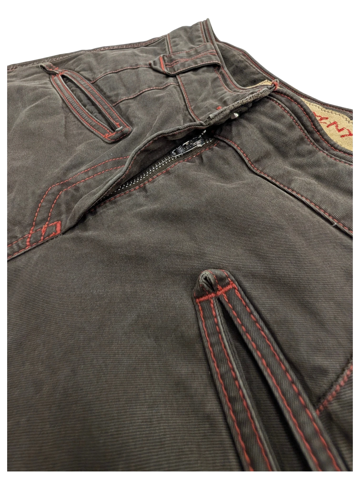 JAKE & IPI dark brown cotton cargo pants with red contrast stitching and zipper detail.