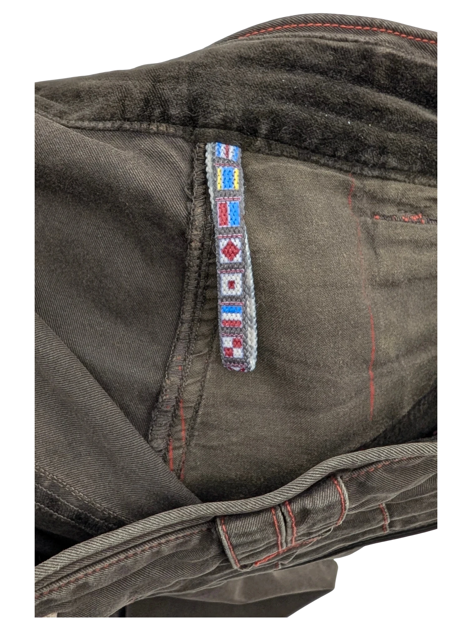 JAKE & IPI dark brown cargo pants with nautical flag trim detail and red stitching.
