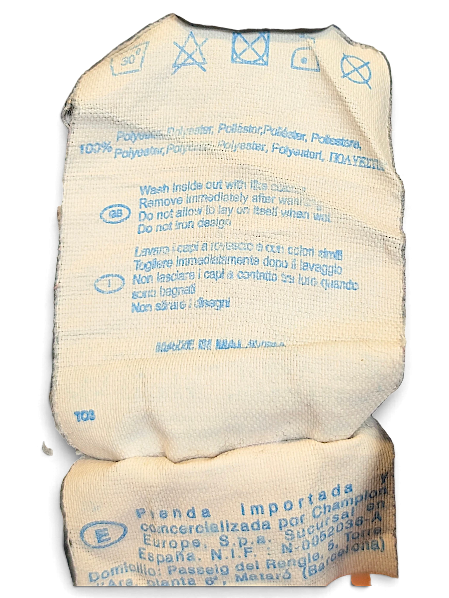 JAKE & IPI Champion track pants care and composition label showing 100 percent polyester material details