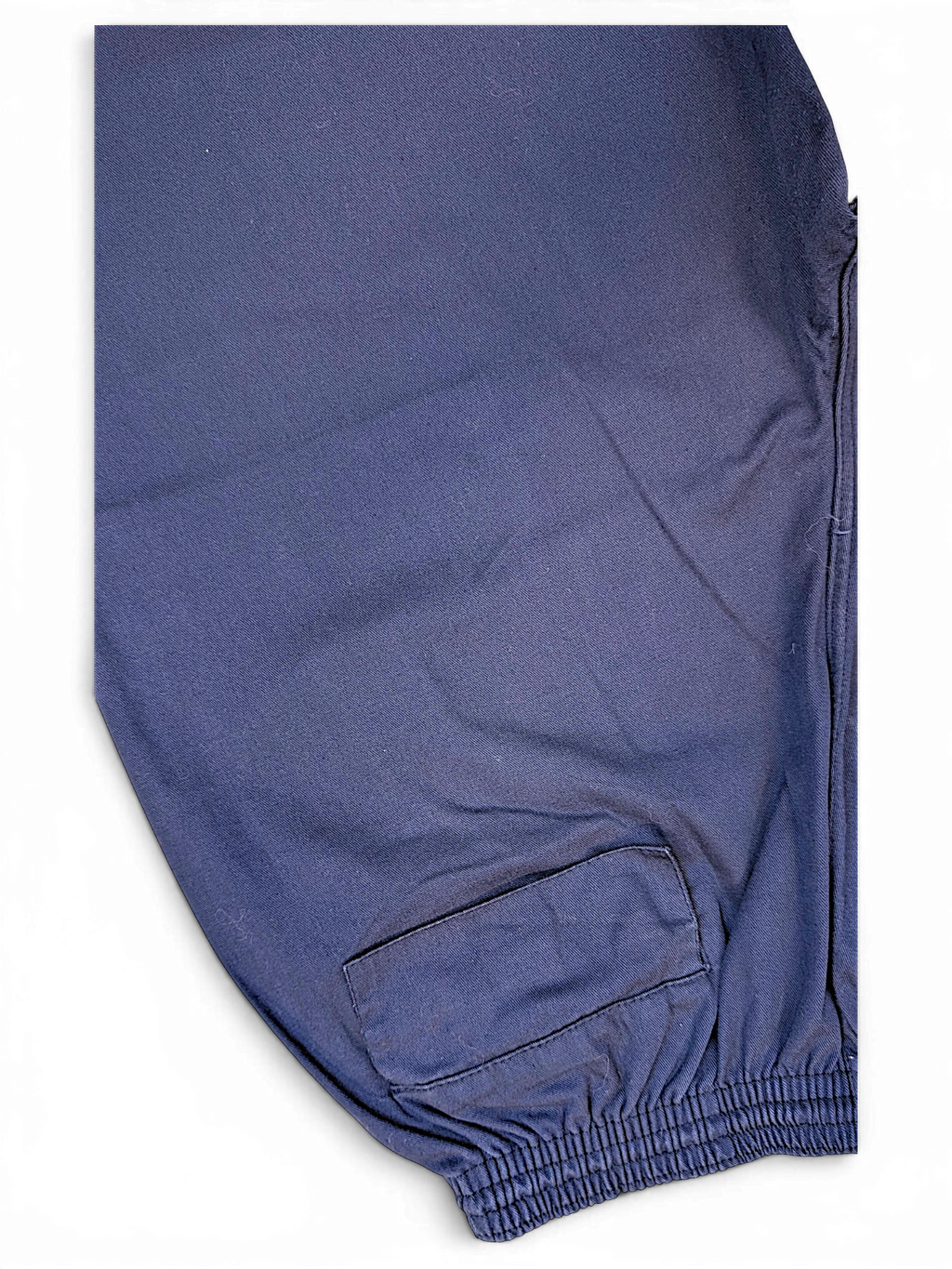 JAKE & IPI pre-owned Champion track pants in a relaxed, faded blue fabric with an elasticated cuff detail.