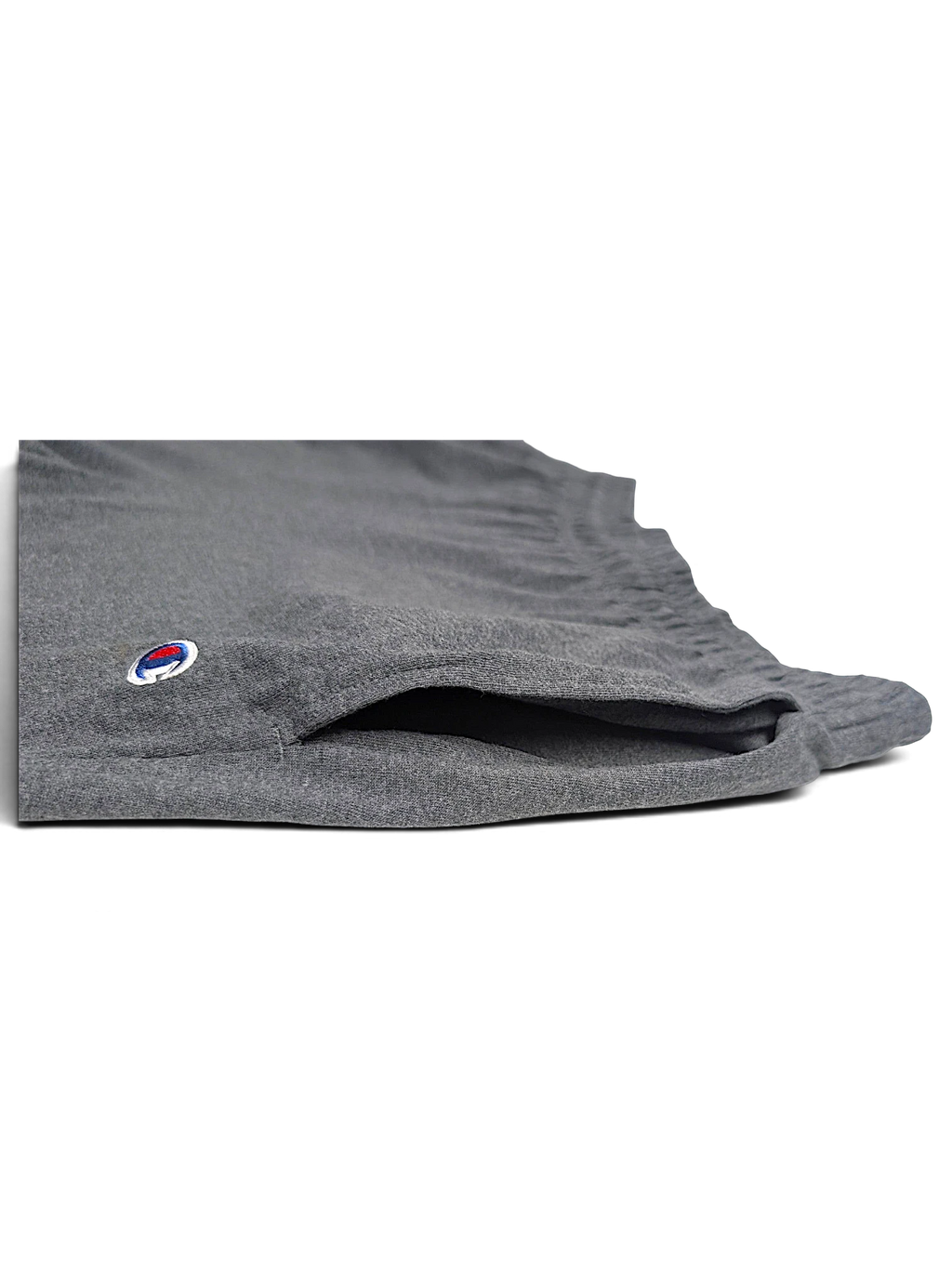 JAKE & IPI Champion light grey fleece joggers featuring a side pocket and embroidered logo detail.
