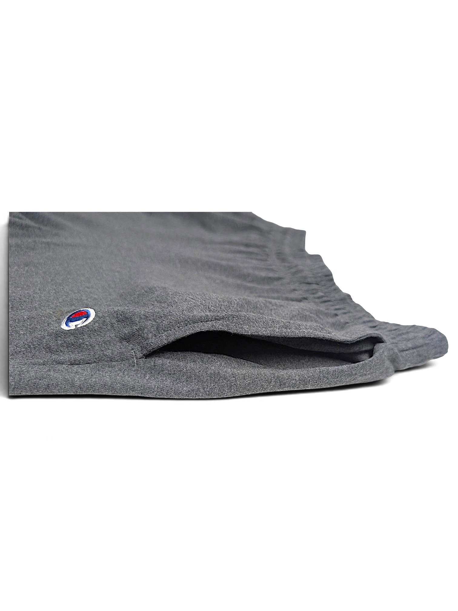 JAKE & IPI Champion light grey fleece joggers featuring a side pocket and embroidered logo detail.