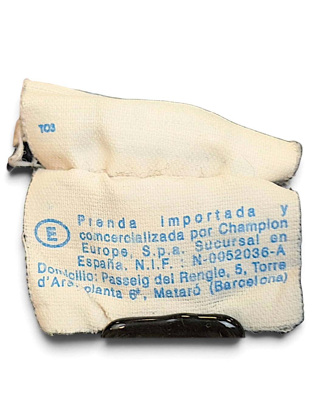 JAKE & IPI Champion track pants interior fabric care and origin label with blue text on white background