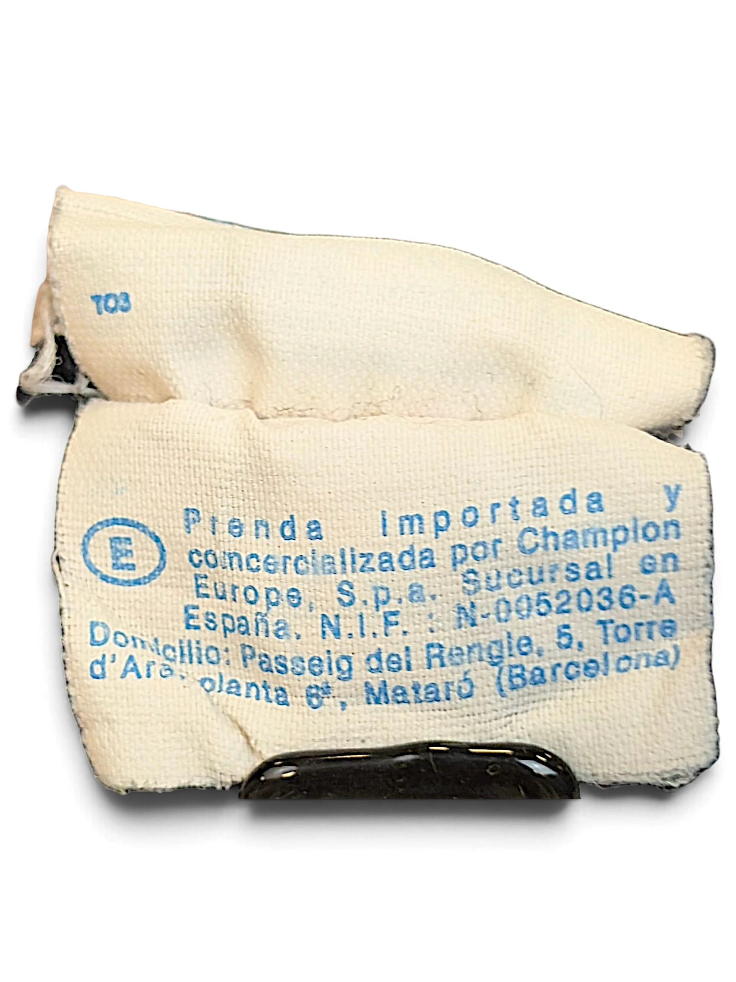 JAKE & IPI Champion track pants interior fabric care and origin label with blue text on white background