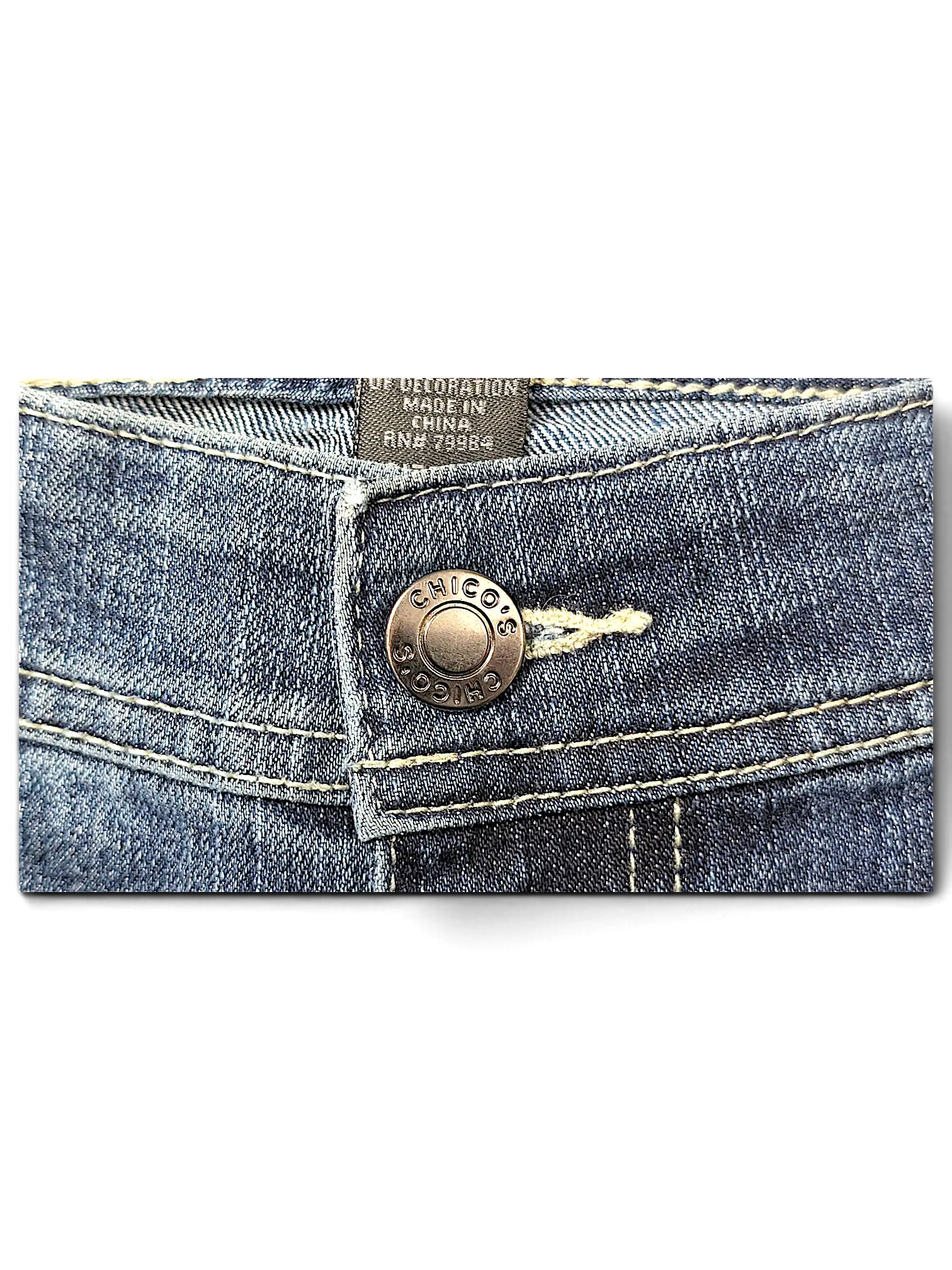 JAKE & IPI Additions by Chico's denim shorts featuring a branded metal button and contrast stitching detail.