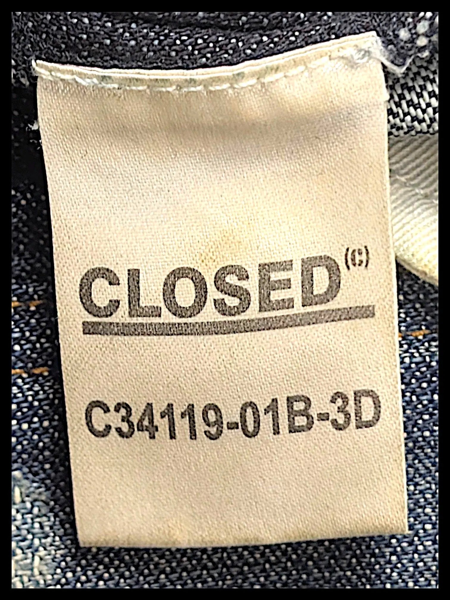 JAKE & IPI Closed brand denim jeans interior care label with model number C34119-01B-3D on blue fabric