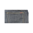 Close-up of a dark blue denim back pocket on JAKE & IPI Closed jeans with orange contrast stitching and logo tag.