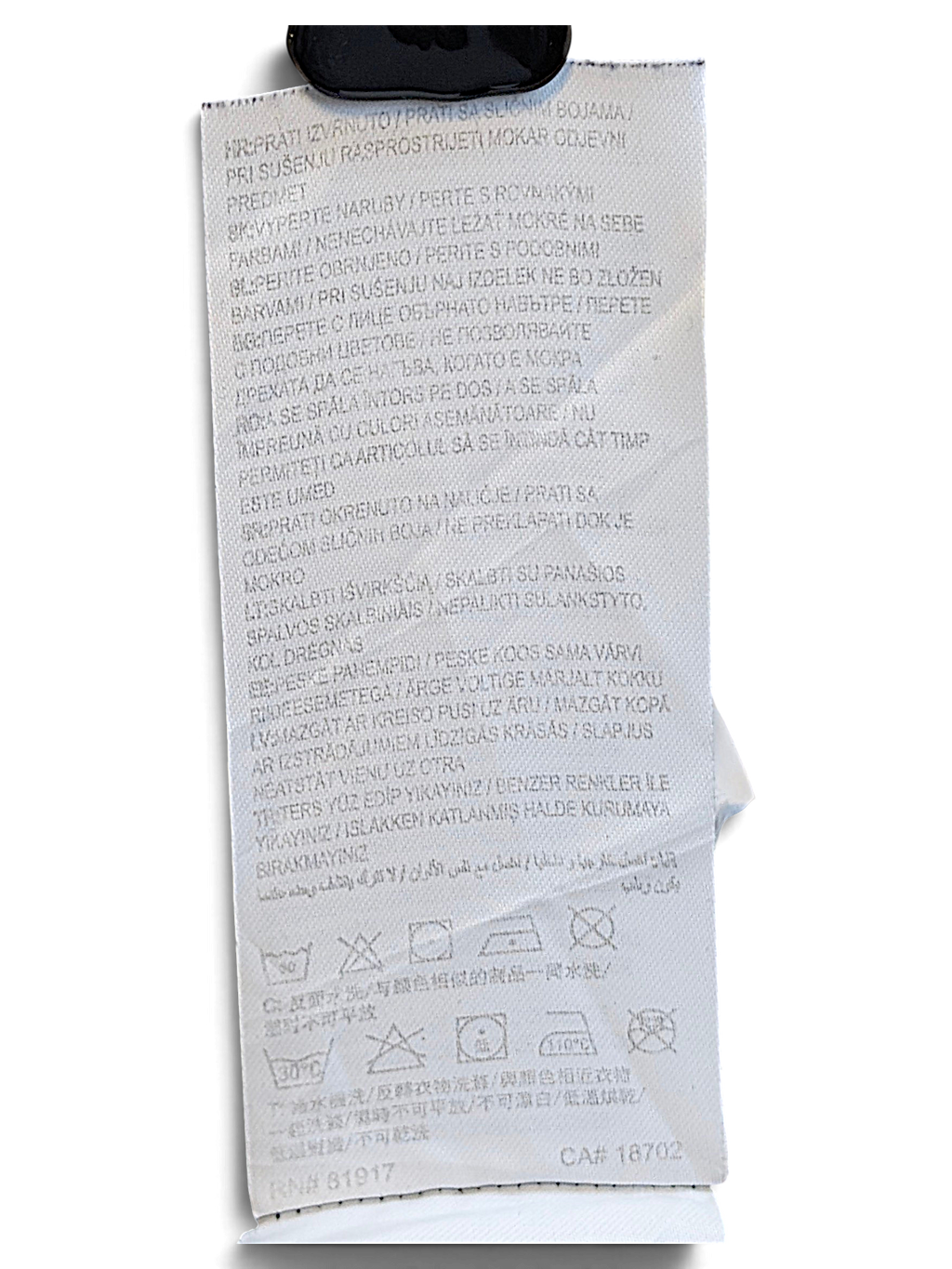 JAKE & IPI Converse Cropped College garment care label with washing instructions and symbols on dark fabric