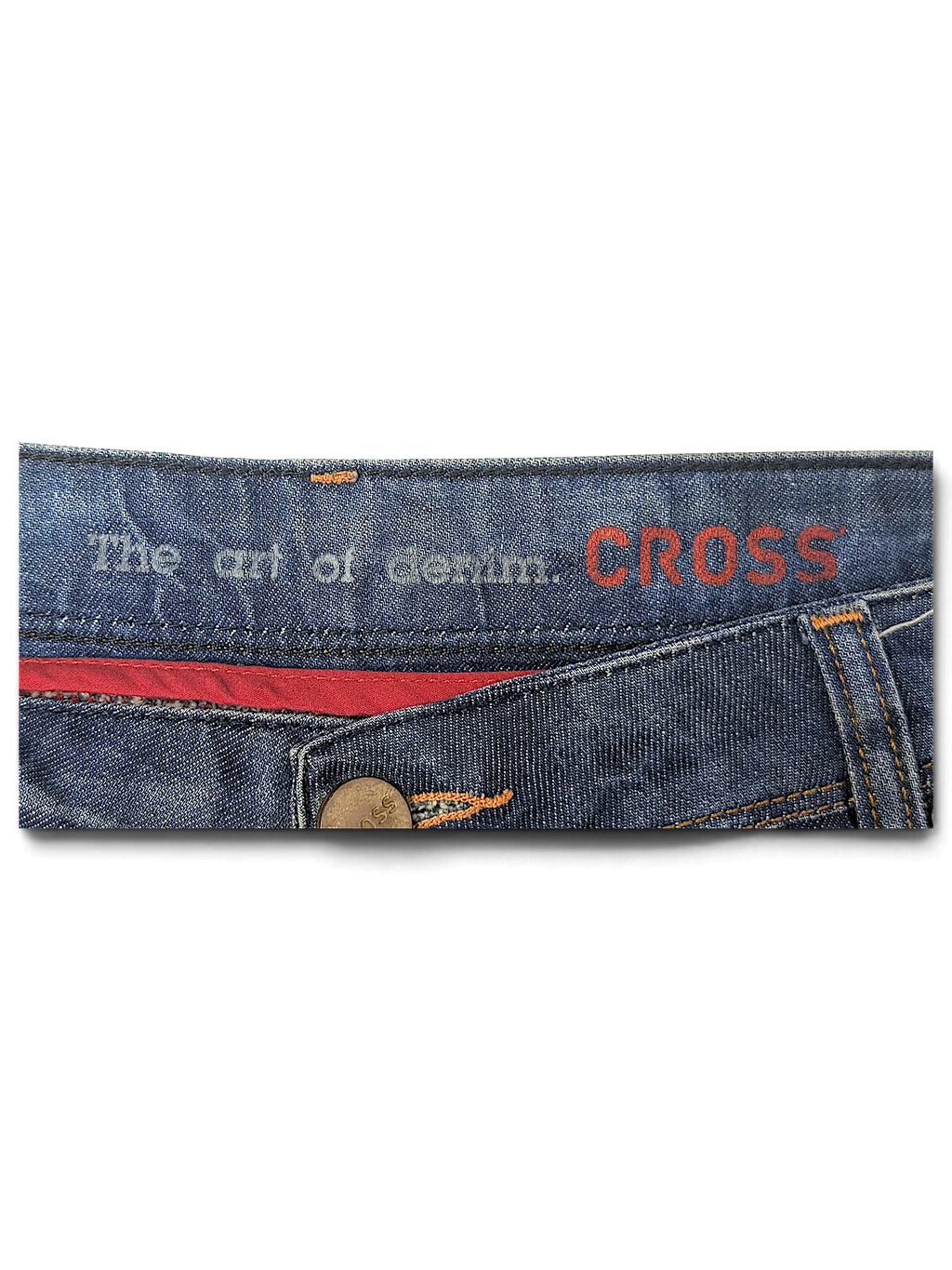 JAKE & IPI blue denim jeans waistband featuring The art of denim Cross branding and red interior lining detail