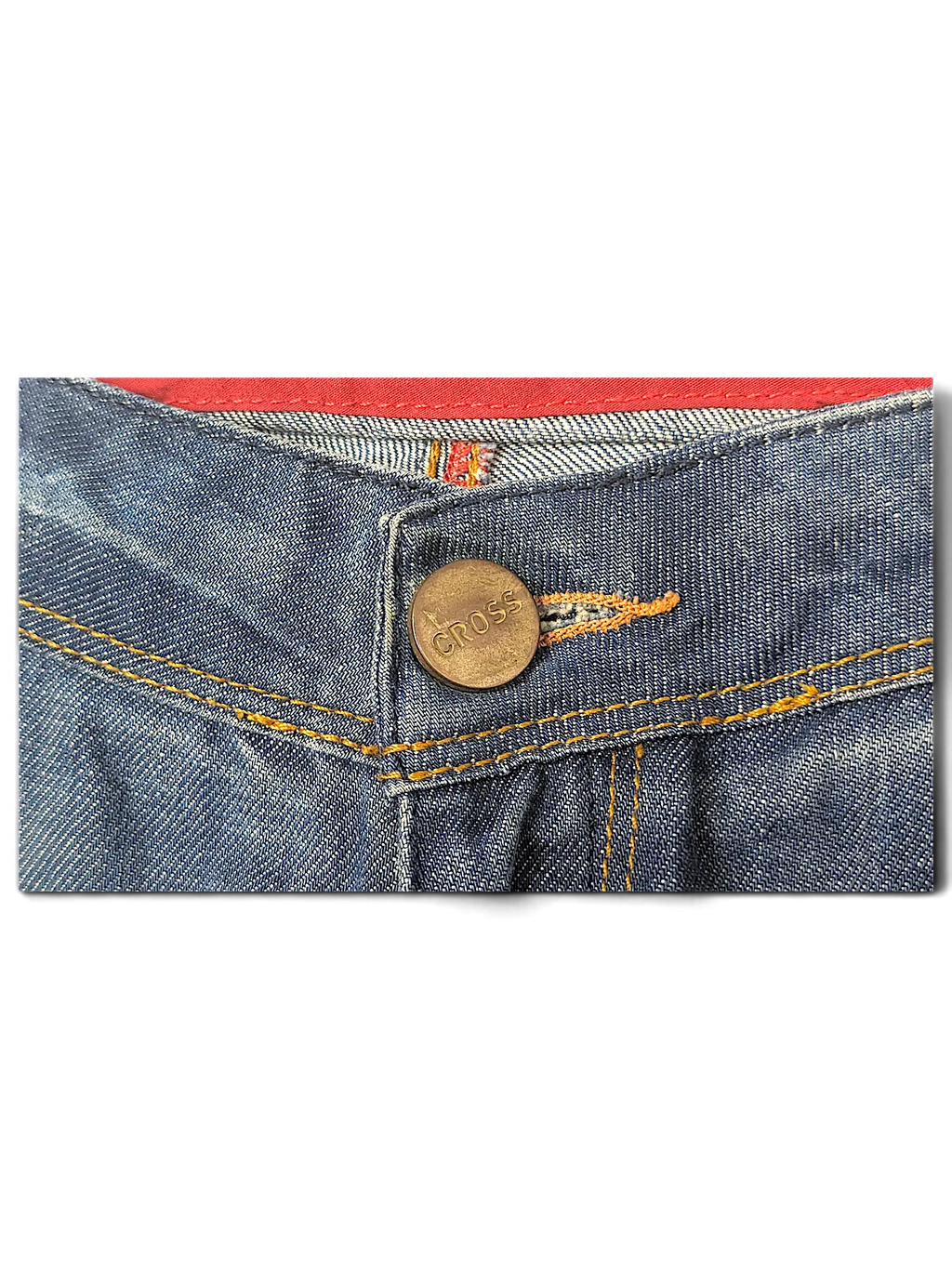 JAKE & IPI blue denim jeans featuring a brass button embossed with the Cross logo and contrast orange stitching.