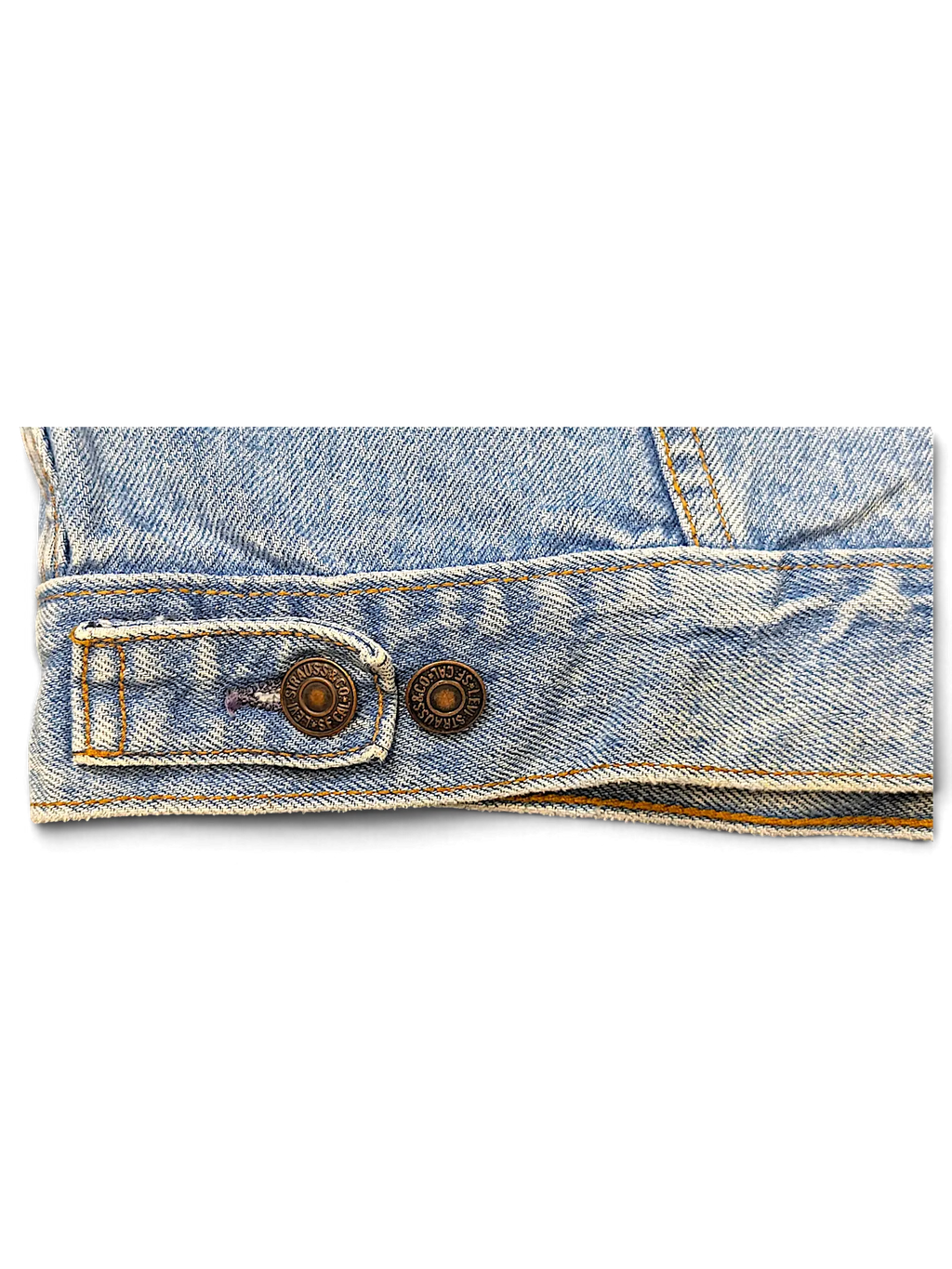JAKE & IPI vintage light wash denim jacket hem detail with branded metal buttons and adjustable side tab