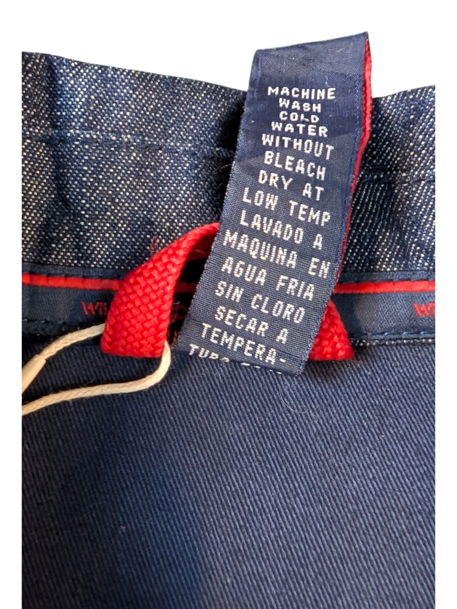 JAKE & IPI Willie Esco denim jacket care label showing machine wash cold, no bleach, dry on low temp.