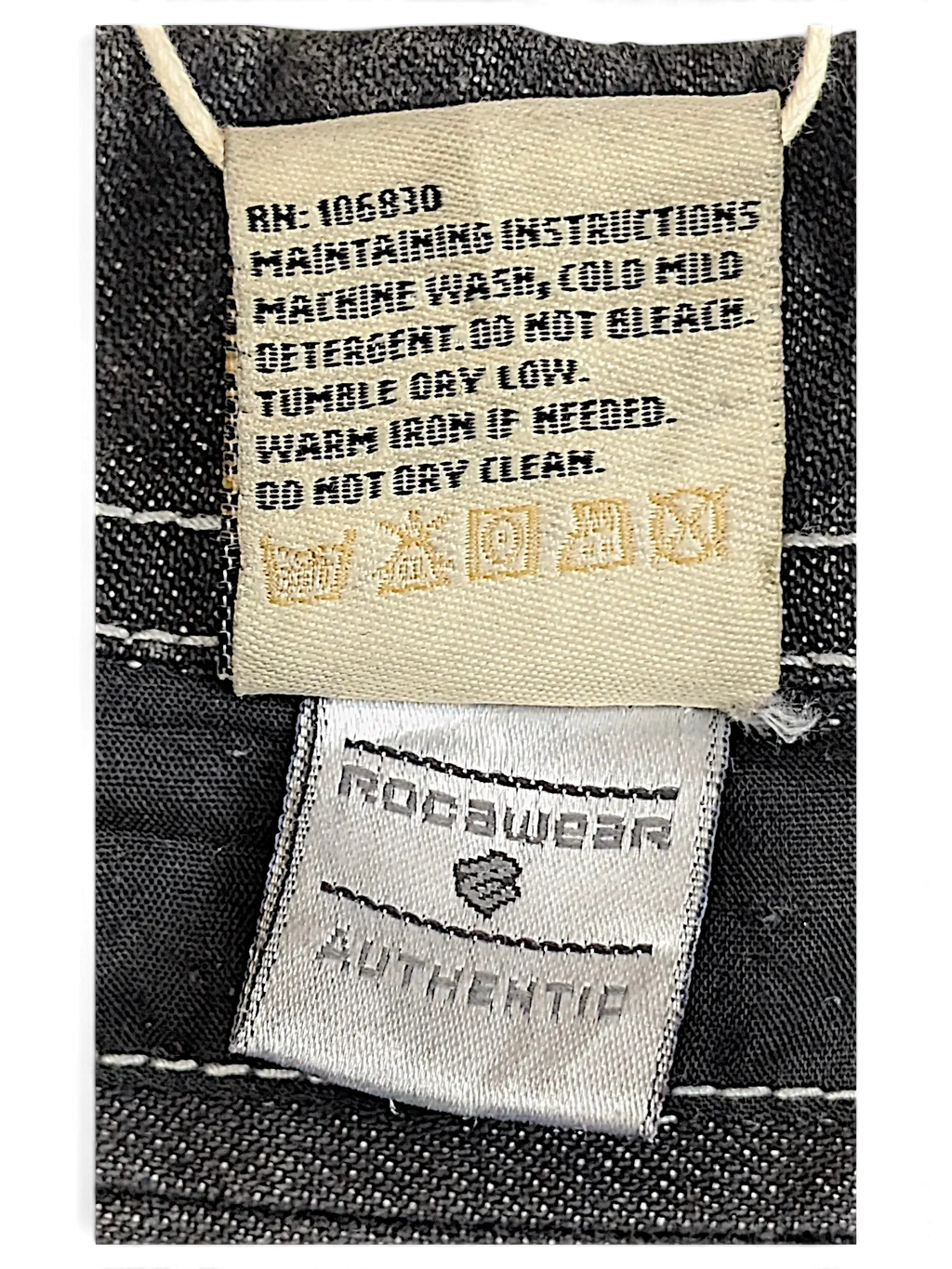 JAKE & IPI dark wash denim work jacket interior care label with white contrast stitching and Rocawear branding
