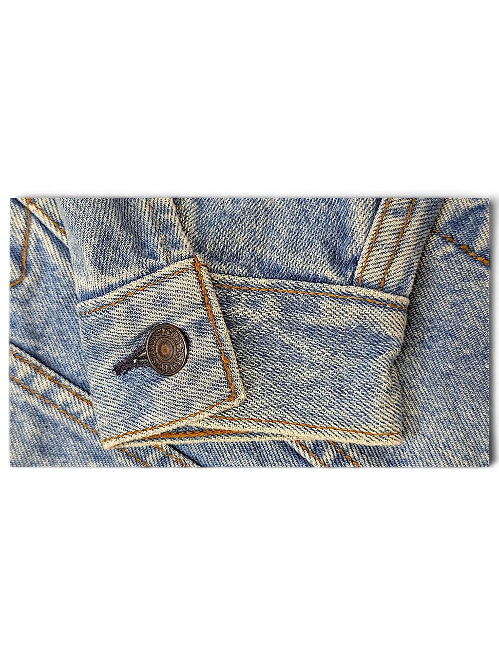JAKE & IPI light wash blue denim jacket sleeve cuff with metallic button and contrast stitching
