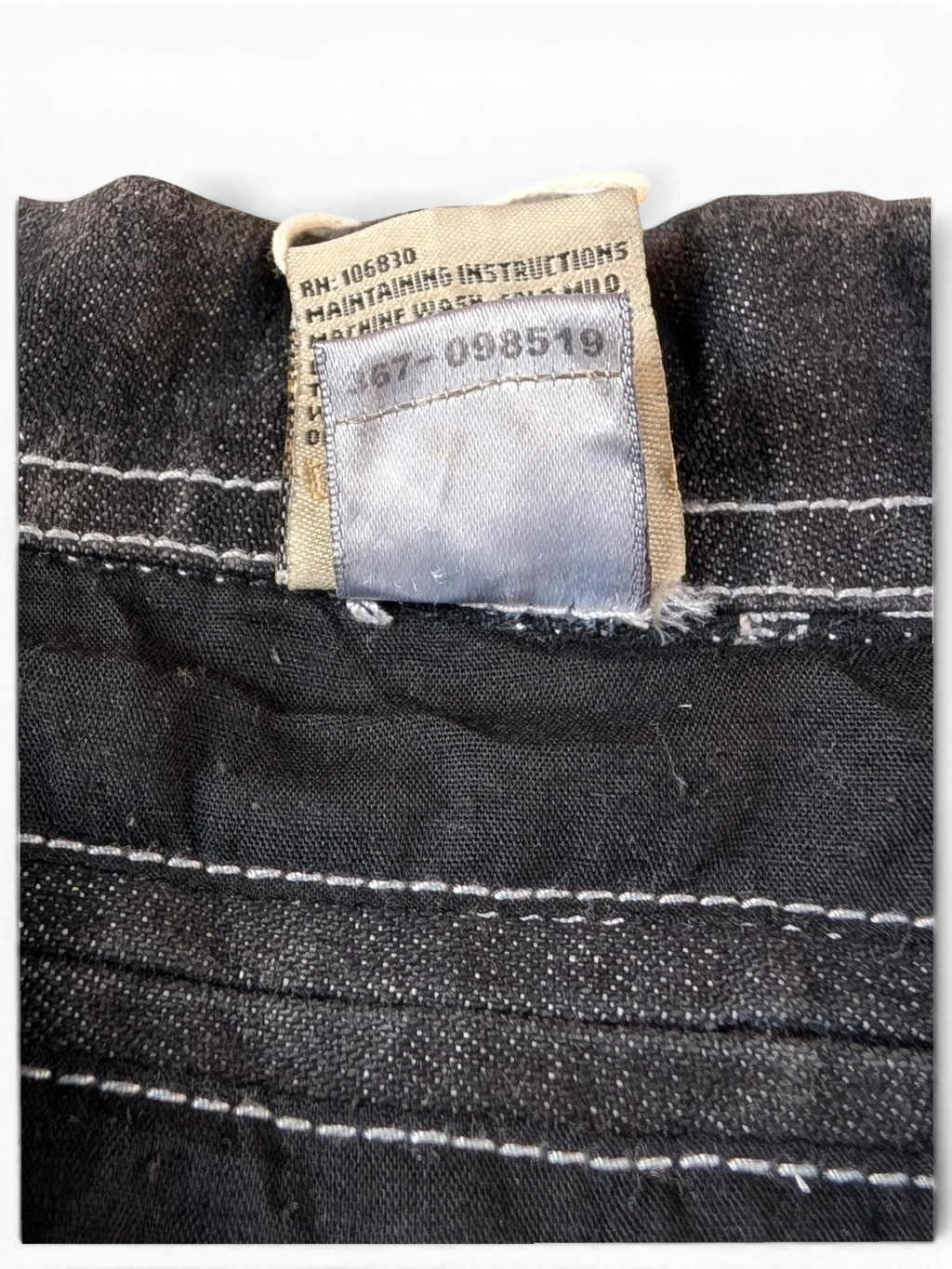JAKE & IPI State Property dark wash denim jacket with white contrast stitching and care label.